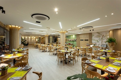 a large dining room with tables and chairs and a sign that says ' tropical ' on it - 