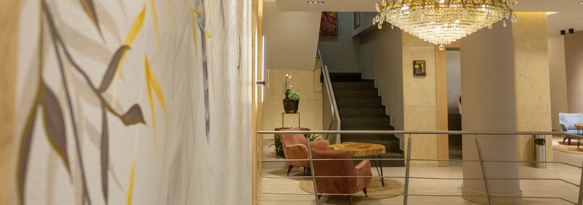 a chandelier hangs from the ceiling above a staircase