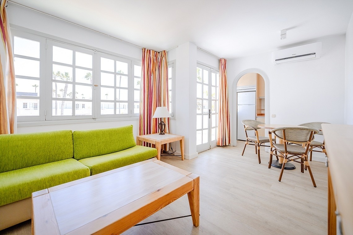 a living room with a green couch and a table
