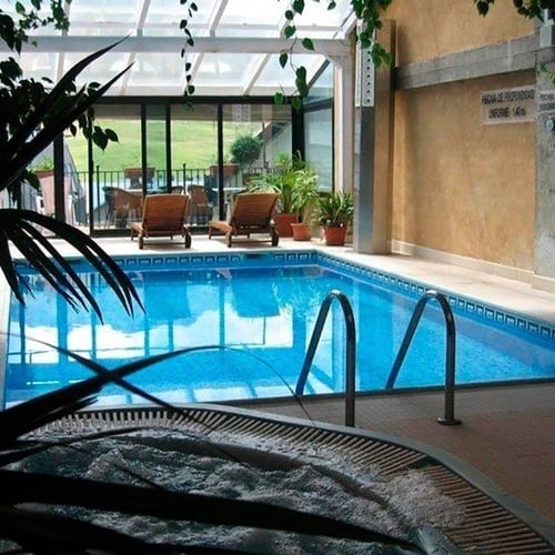 una piscina con un jacuzzi al lado de ella
