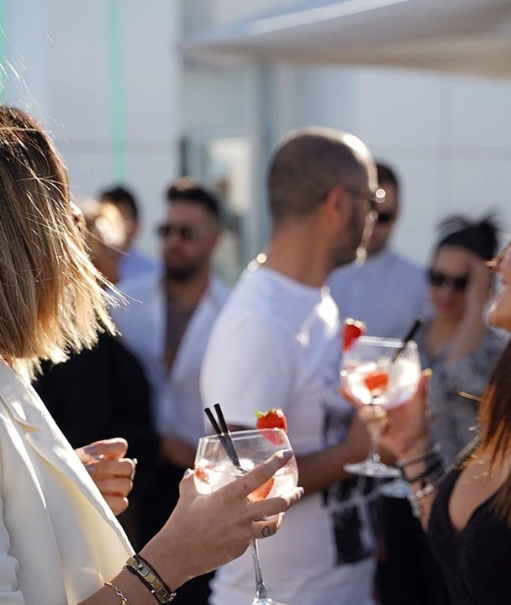 a woman sits on a pier looking at the ocean