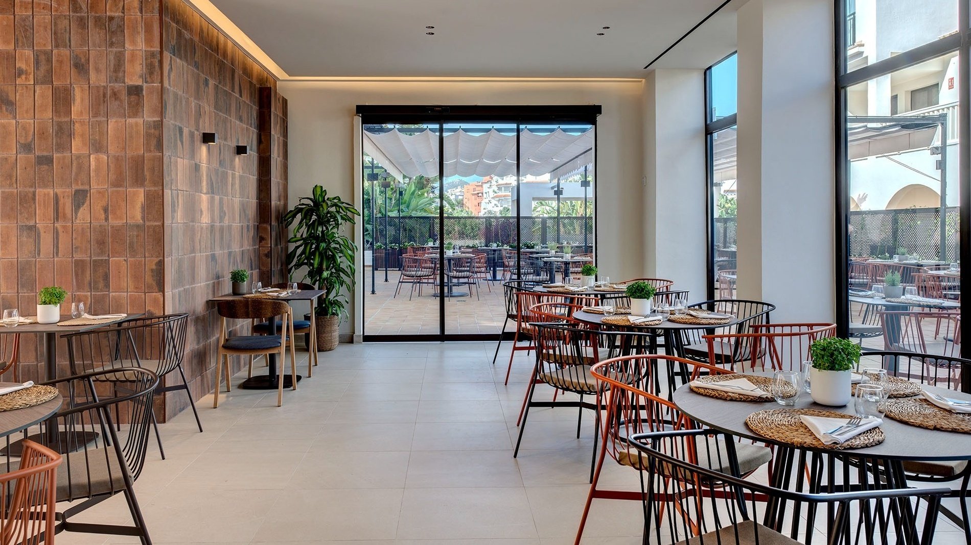 las mesas y sillas están preparadas para una cena en el restaurante ante