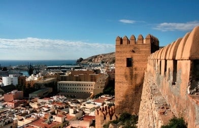 an aerial view of a city with a castle in the background .