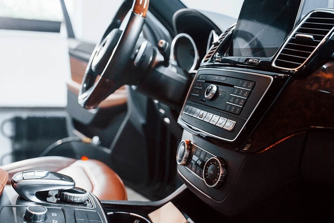 the interior of a car with a steering wheel and dashboard