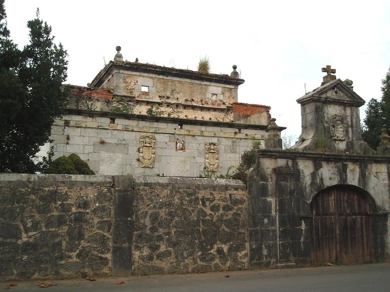 a stone building with a cross on top of it