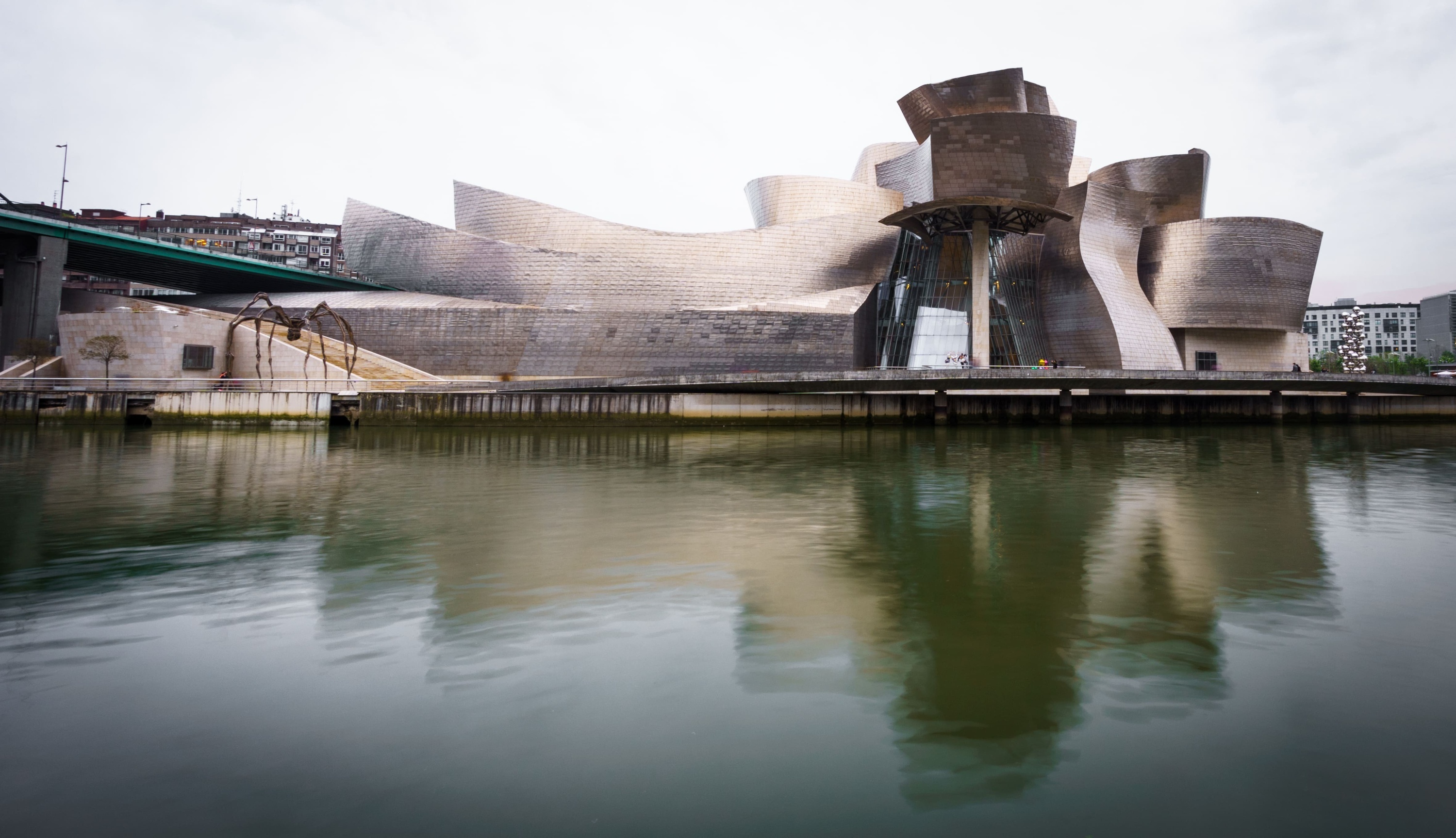 a large building is reflected in a body of water