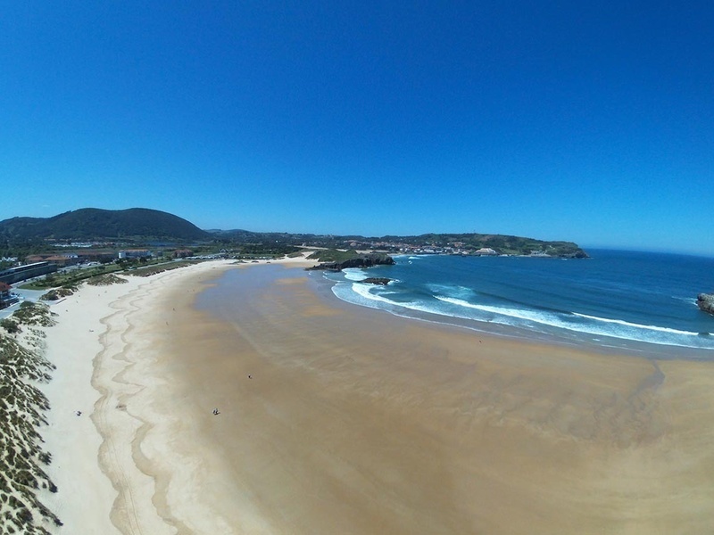 an aerial view of a beach with waves coming in