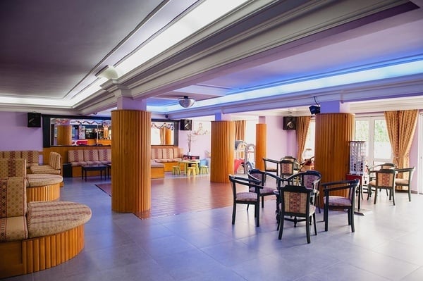 a large room with tables and chairs and a dance floor