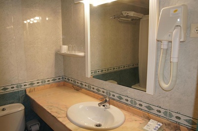 a bathroom with a toilet a sink and a mirror