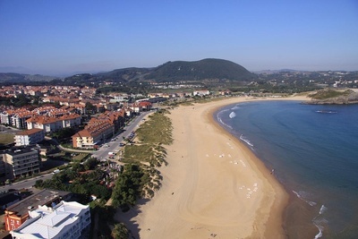 an aerial view of a beach with a building that says ' hotel ' on it - 