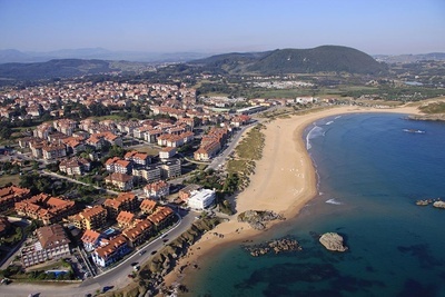 an aerial view of a beach with a city in the background - 