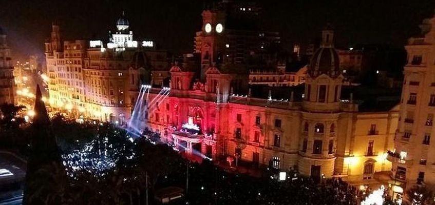 un gran edificio está iluminado con luces rojas y blancas .