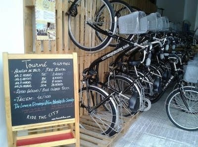 a bunch of bicycles are lined up next to a chalkboard .