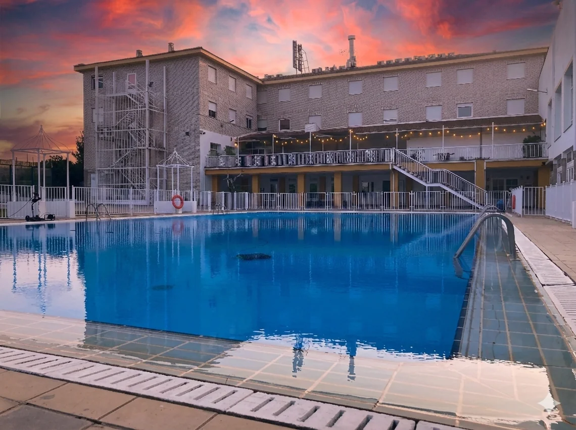 Acosta: Ciudad de la Musica's large outdoor swimming pool, lush gardens, and al fresco dining area.