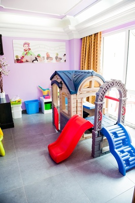 a playhouse with a slide and stairs in a room - 