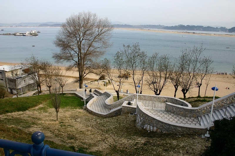a view of a beach with stairs leading up to it