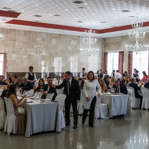 Elegant banquet hall with long tables, chandeliers, and guests enjoying a meal at Hotel Acosta Ciudad de la Música.