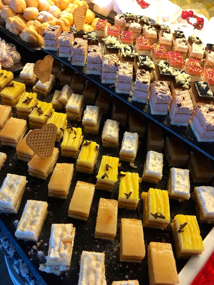 a variety of desserts are displayed on a table