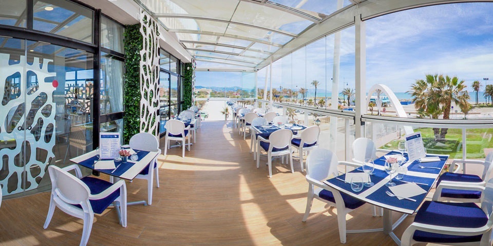 un restaurant avec des tables et des chaises bleues et blanches