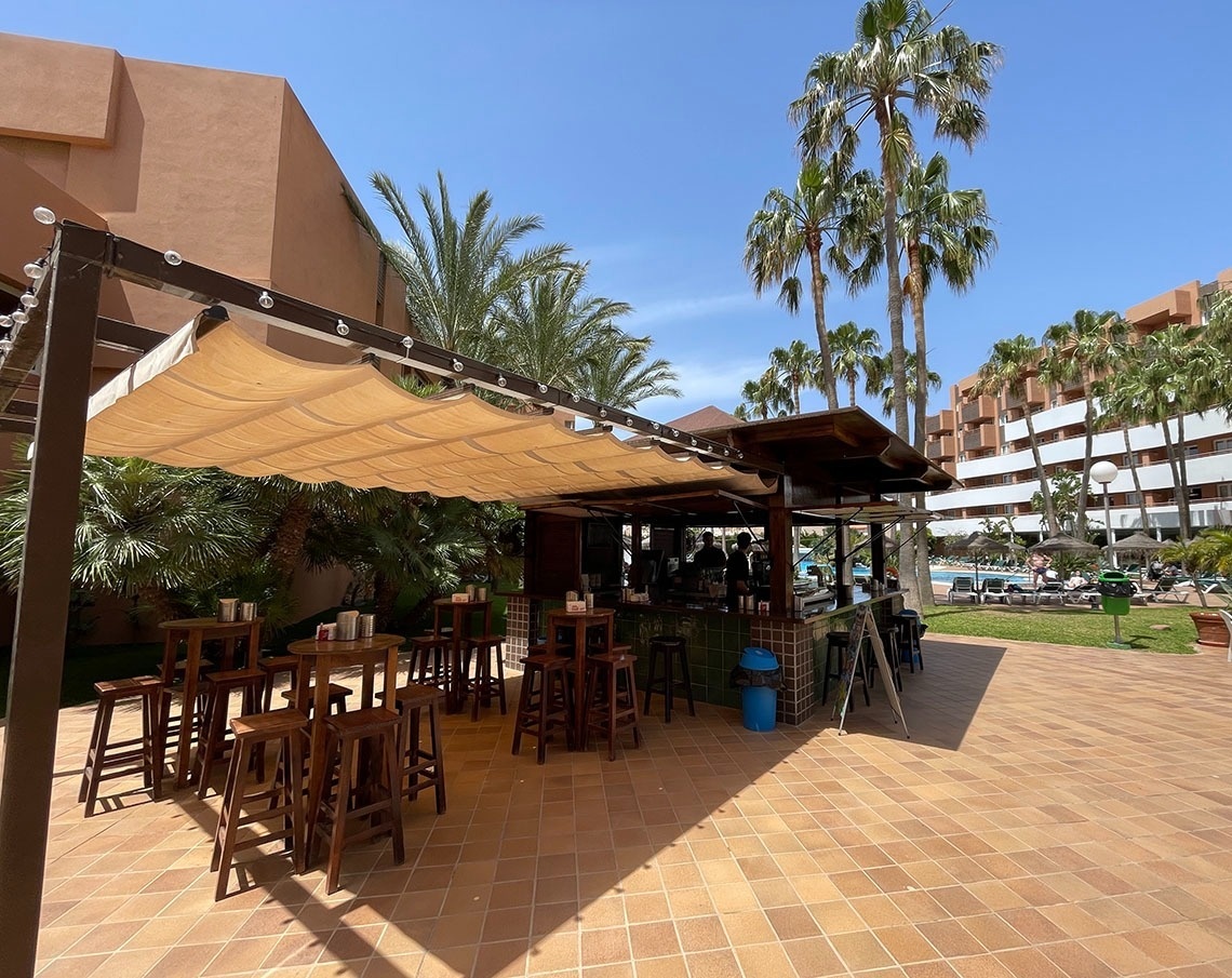 un faro está iluminado por la noche junto a palmeras .