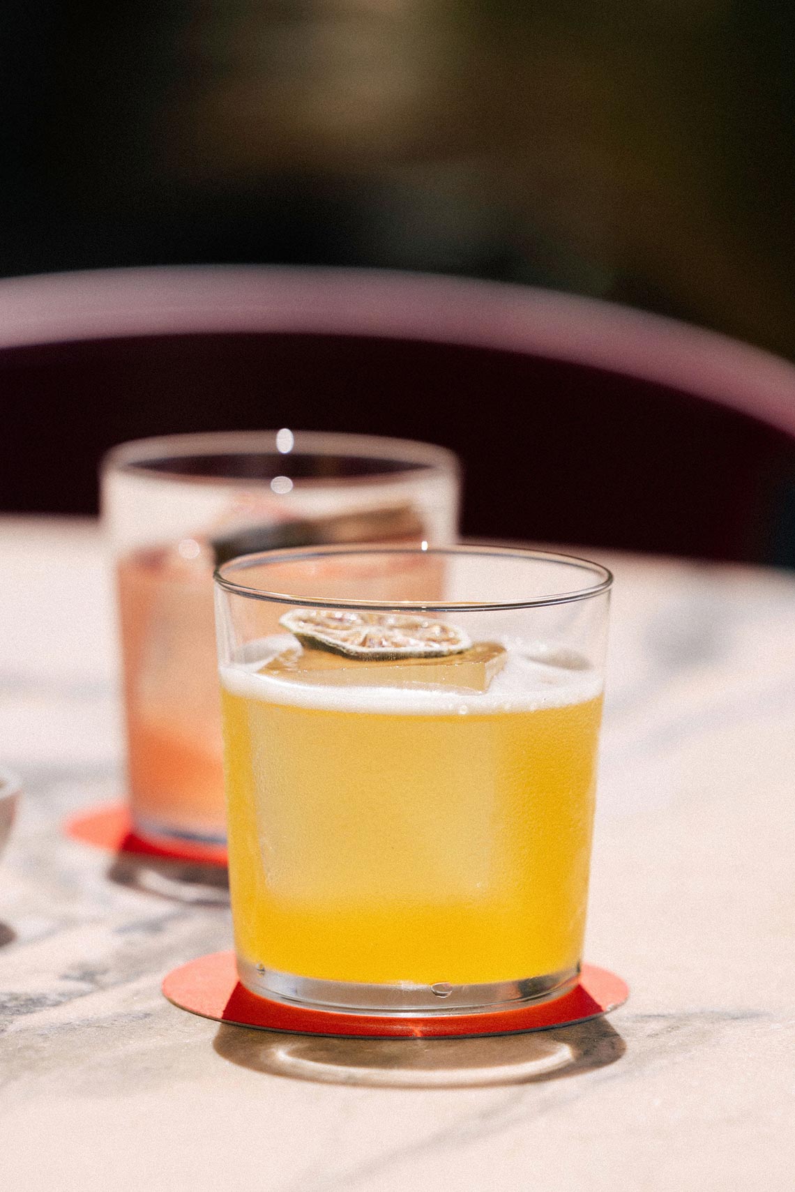 Cóctel refrescante con rodaja de limón y un segundo trago TEST3: Copia 4 en el fondo.