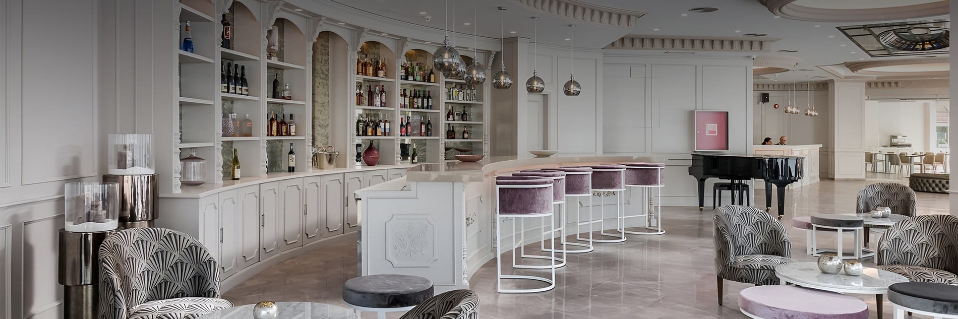 a bar with purple stools and a piano