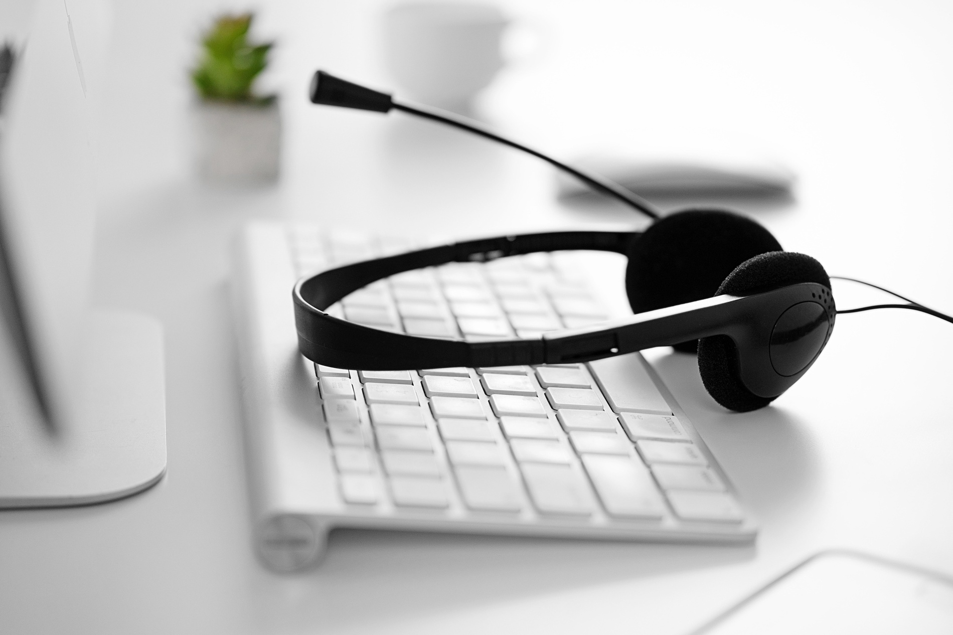 a headset sits on top of a white keyboard