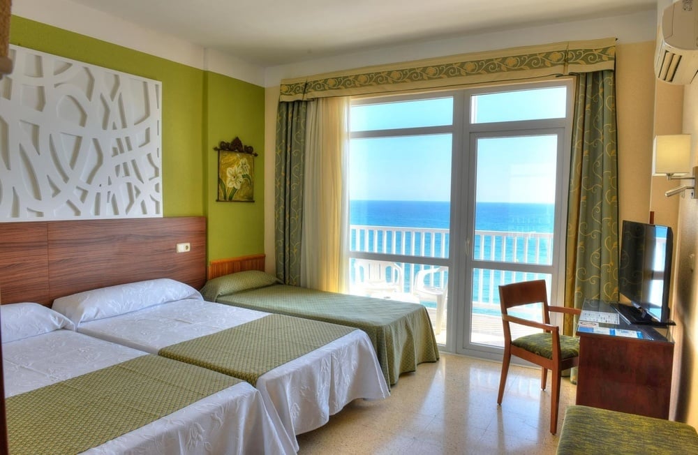 a hotel room with a bed and sea views