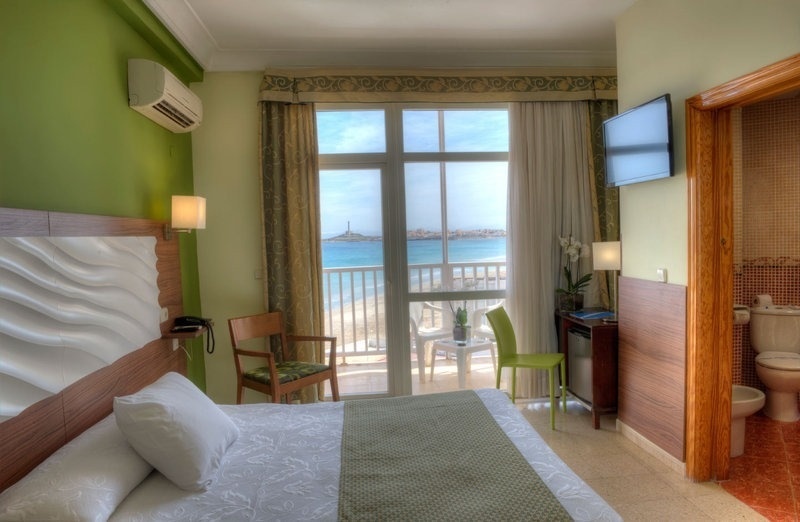 a hotel room with a view of the ocean