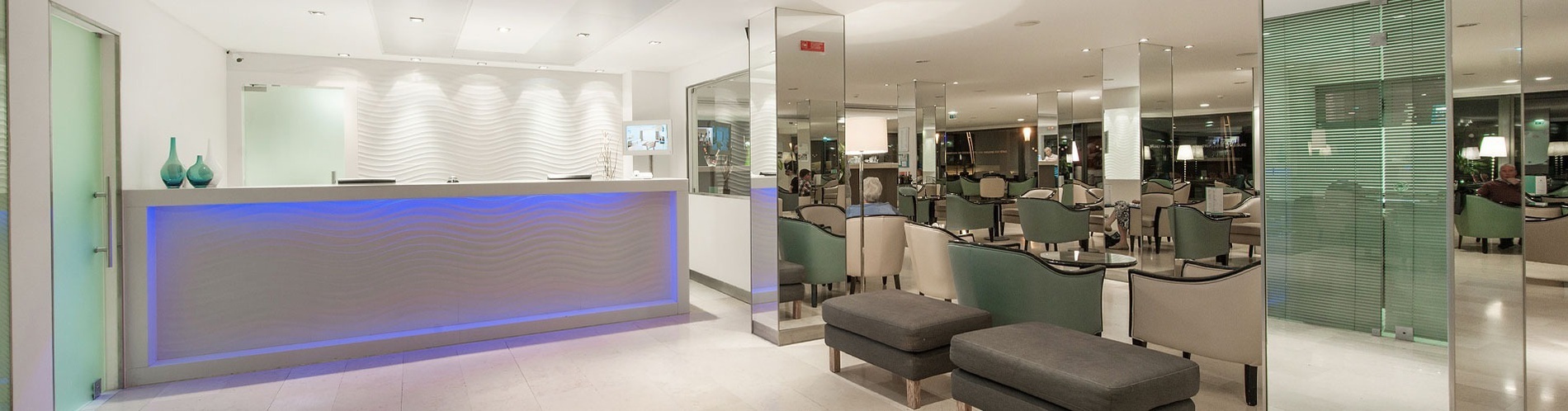 a hotel lobby with a blue light on the front desk