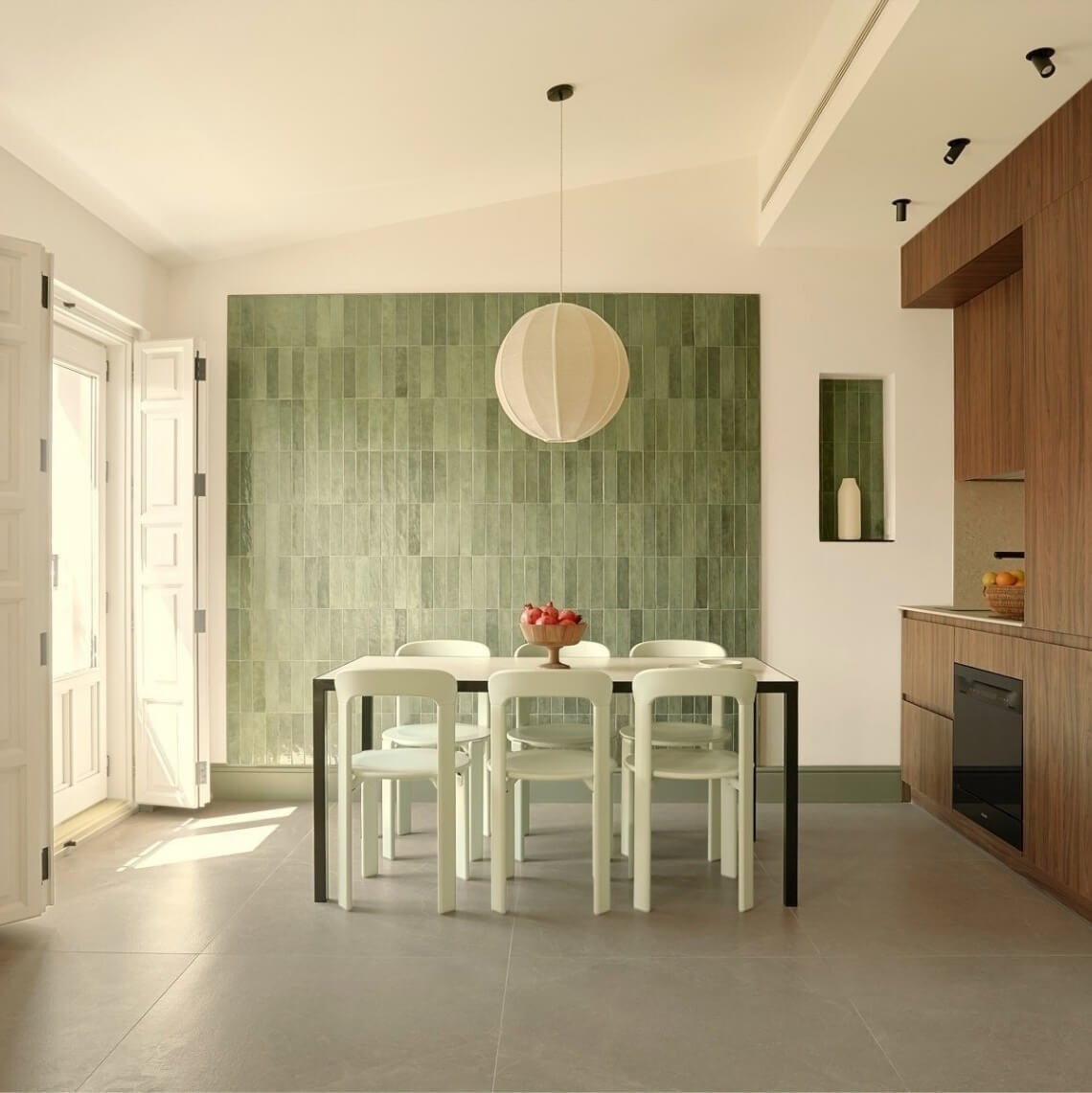Modern dining room with a green wall and elegant design. U-Sense