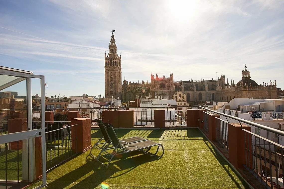 Terrace with sunbeds and views of the Giralda at U-Sense Sevilla Santa Cruz