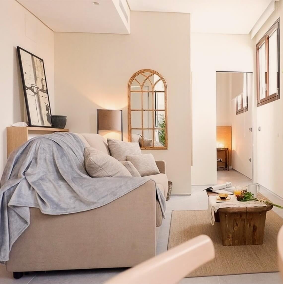Cozy sofa with a blanket in a hotel living room. U-Sense