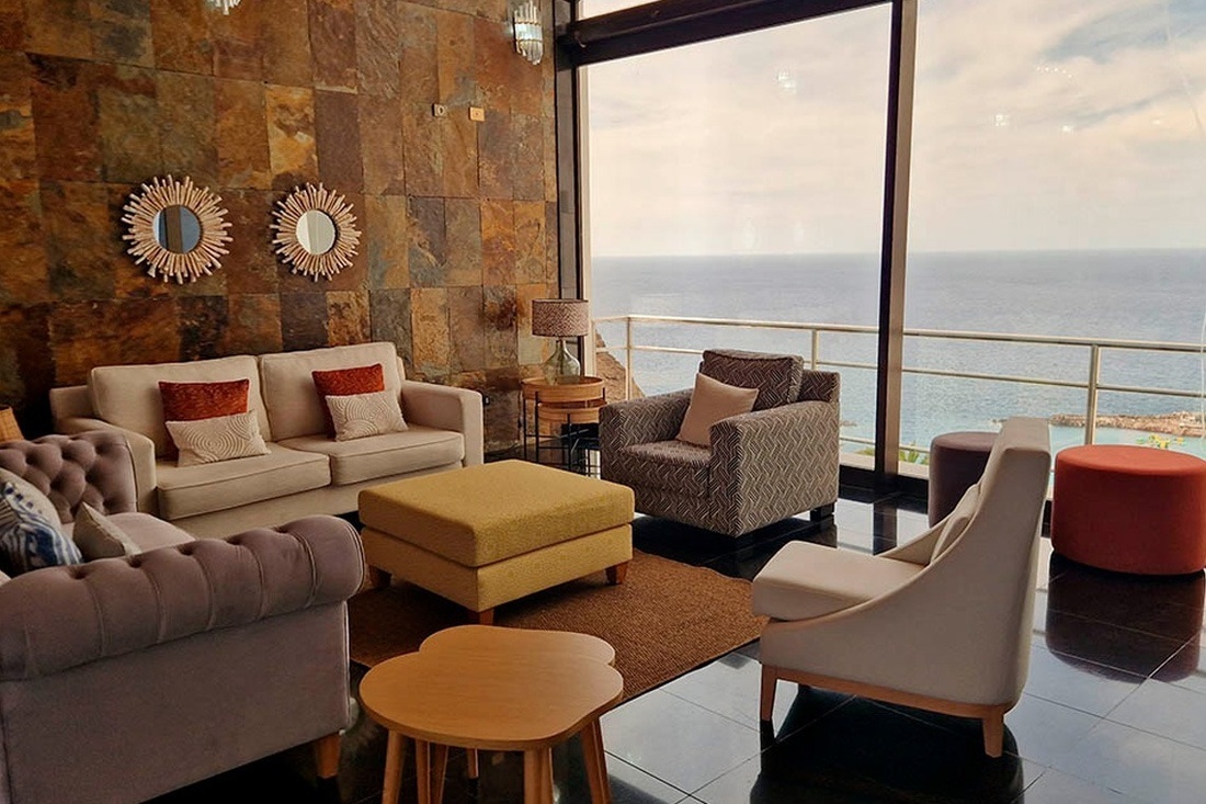 a living room with a view of the ocean