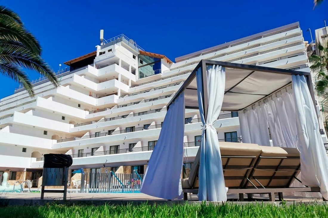 a large white building with a canopy in front of it