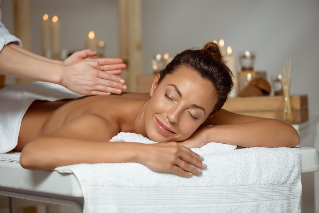 a woman is getting a massage with her eyes closed