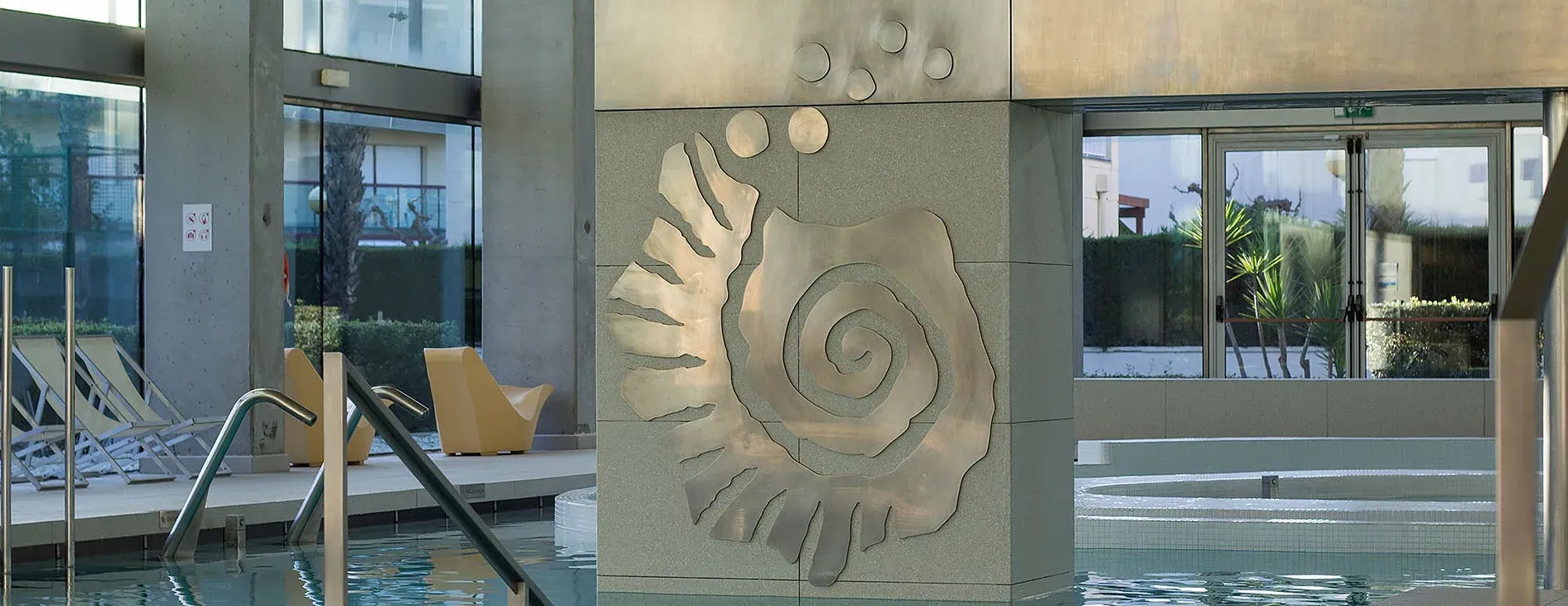 Modern spa with spiral art and chaise lounges. Terms & Conditions | Aquum Spa & Wellness | Tarragona | Official Website.