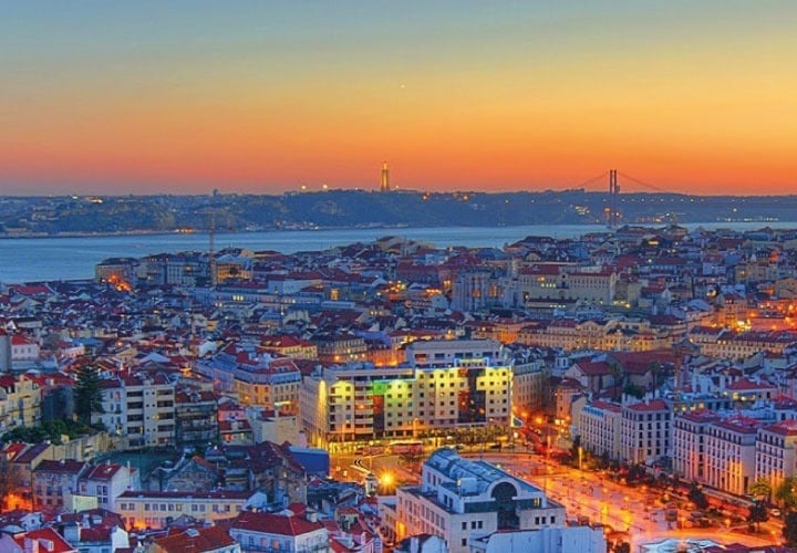 an aerial view of the city of lisbon at sunset