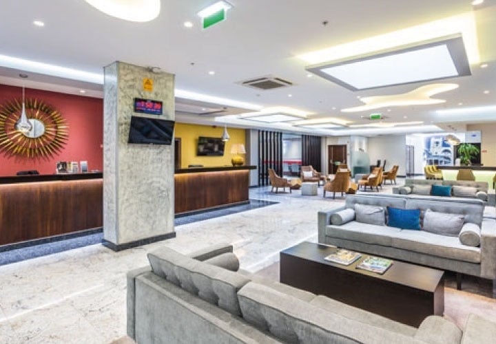 a hotel lobby with a clock on the wall that says 10:08