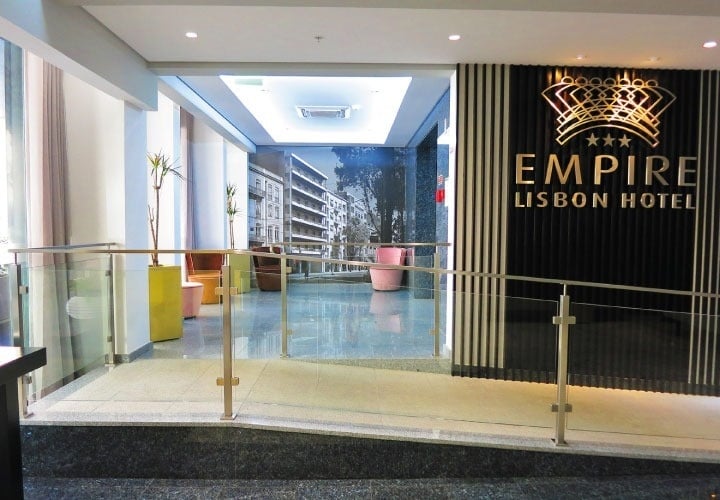 the entrance to the empire lisbon hotel has a glass railing