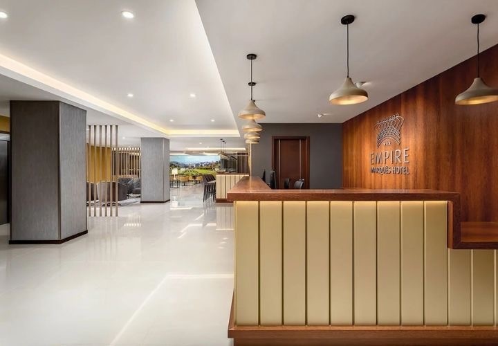 a hotel lobby with a reception desk that says empire
