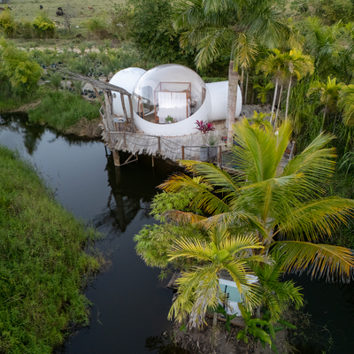 an aerial view of a house in the middle of a river