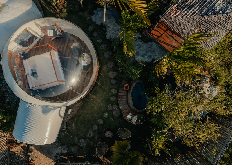 an aerial view of a bubble tent with a bed inside