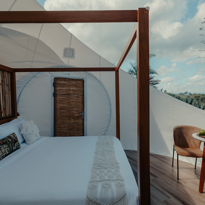 a bedroom with a canopy bed and a table and chairs