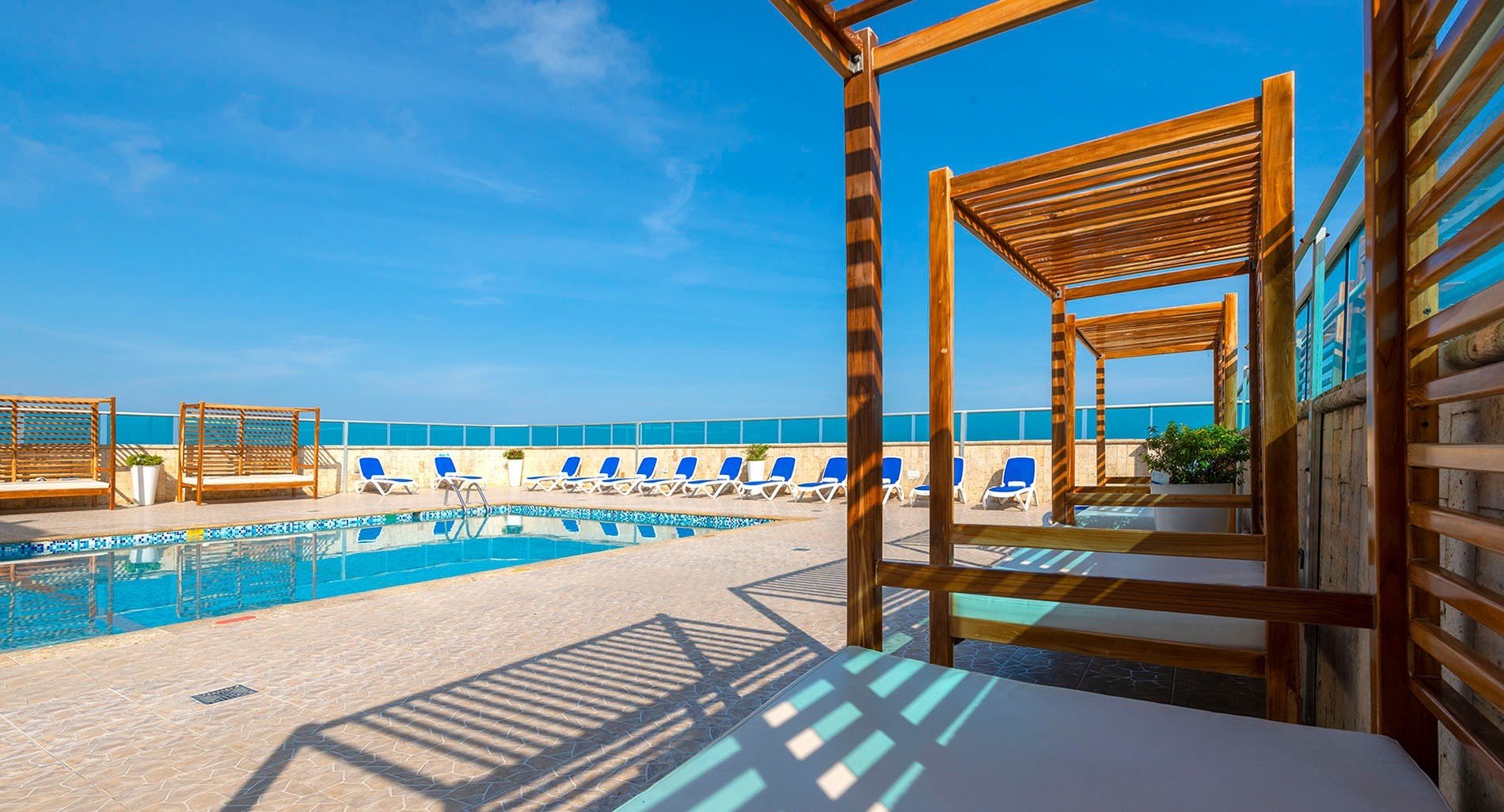 a swimming pool surrounded by chairs and a canopy