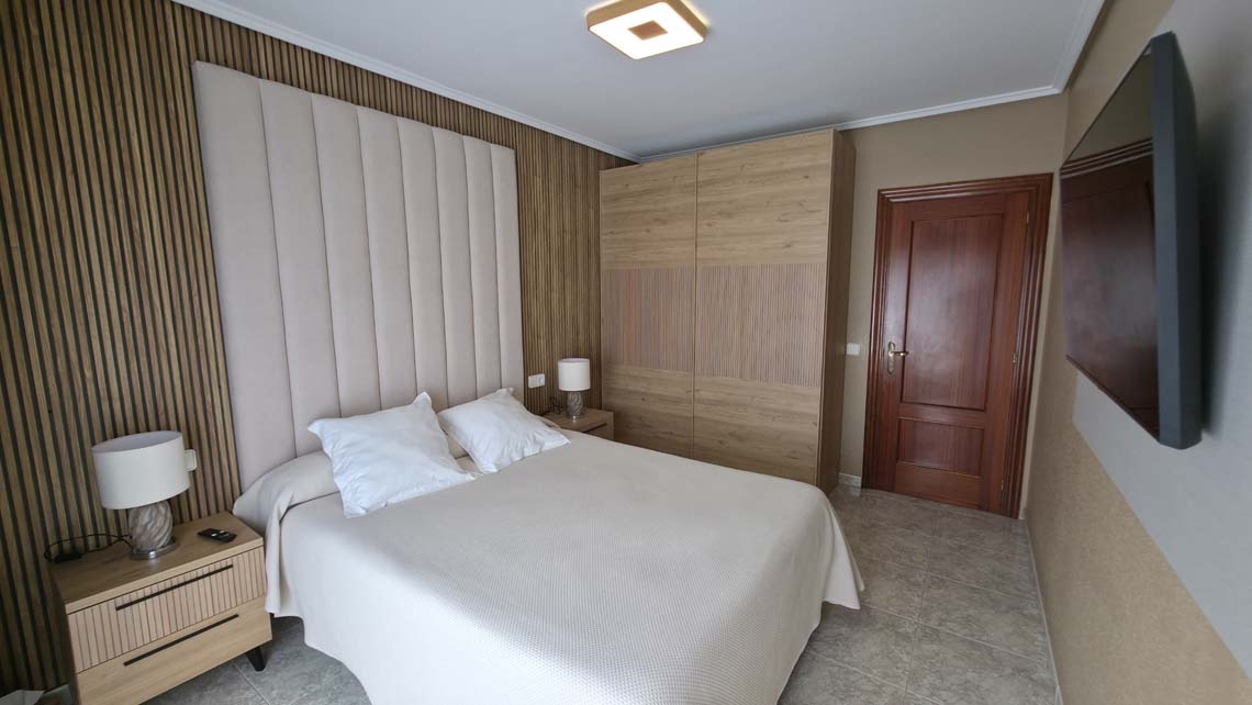 Modern hotel room TEST 4 with wood accents, plush bed, and TV.