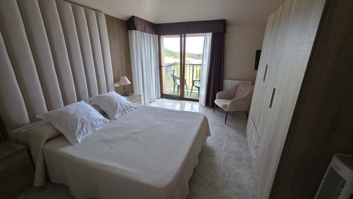 a hotel room with two beds and a striped wall