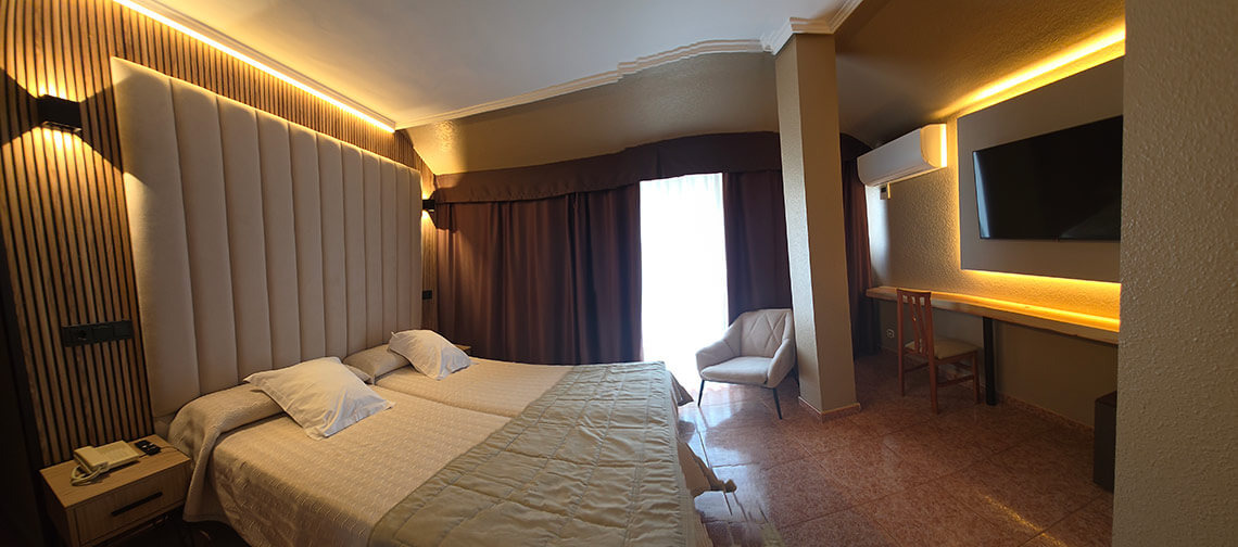 TEST 4: Modern hotel room with two beds, wall-mounted TV, and wood accents.