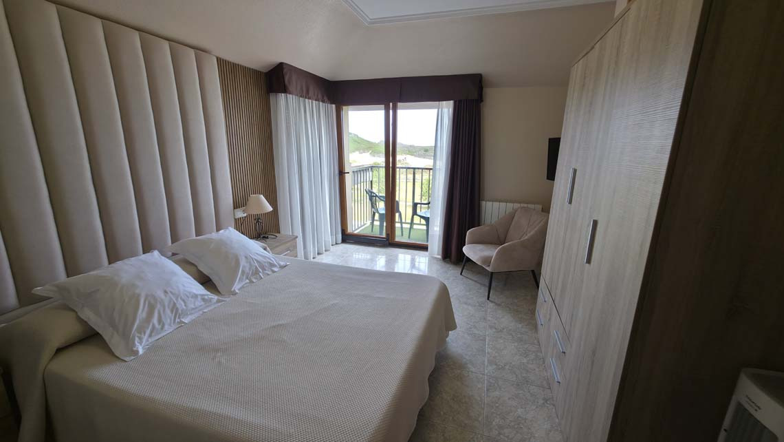 Hotel Room TEST 4: King bed, balcony view, modern closet, and accent chair.