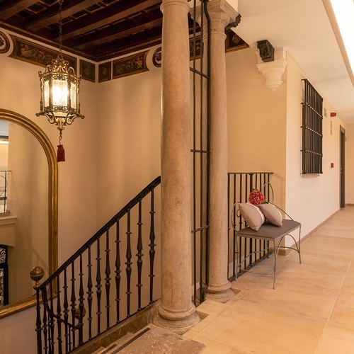 una escalera con una silla y un espejo en el medio